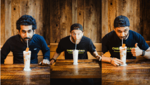 Three Chef on Call Delivery men at a table, drinks placed before them, sharing a moment together.
